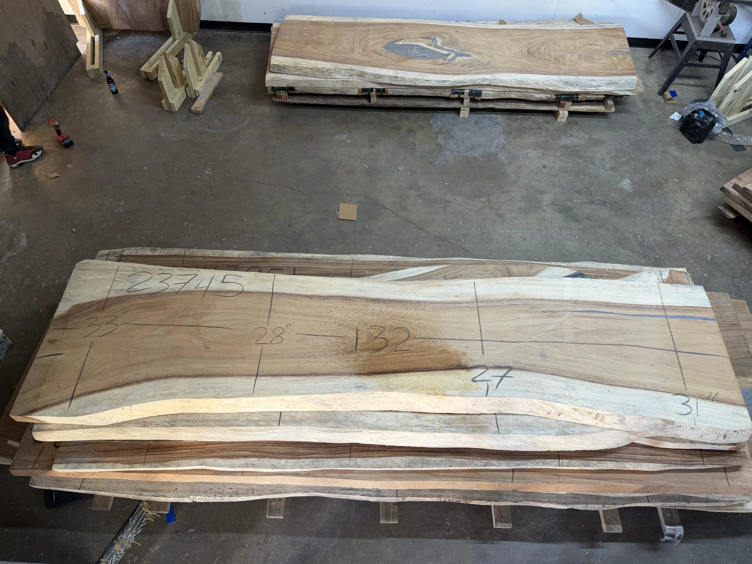 stack of live edge slabs on a concrete floor