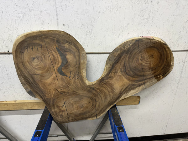 Monkey Pod wood slab  in the shape of a heart, standing upright on a white background.

