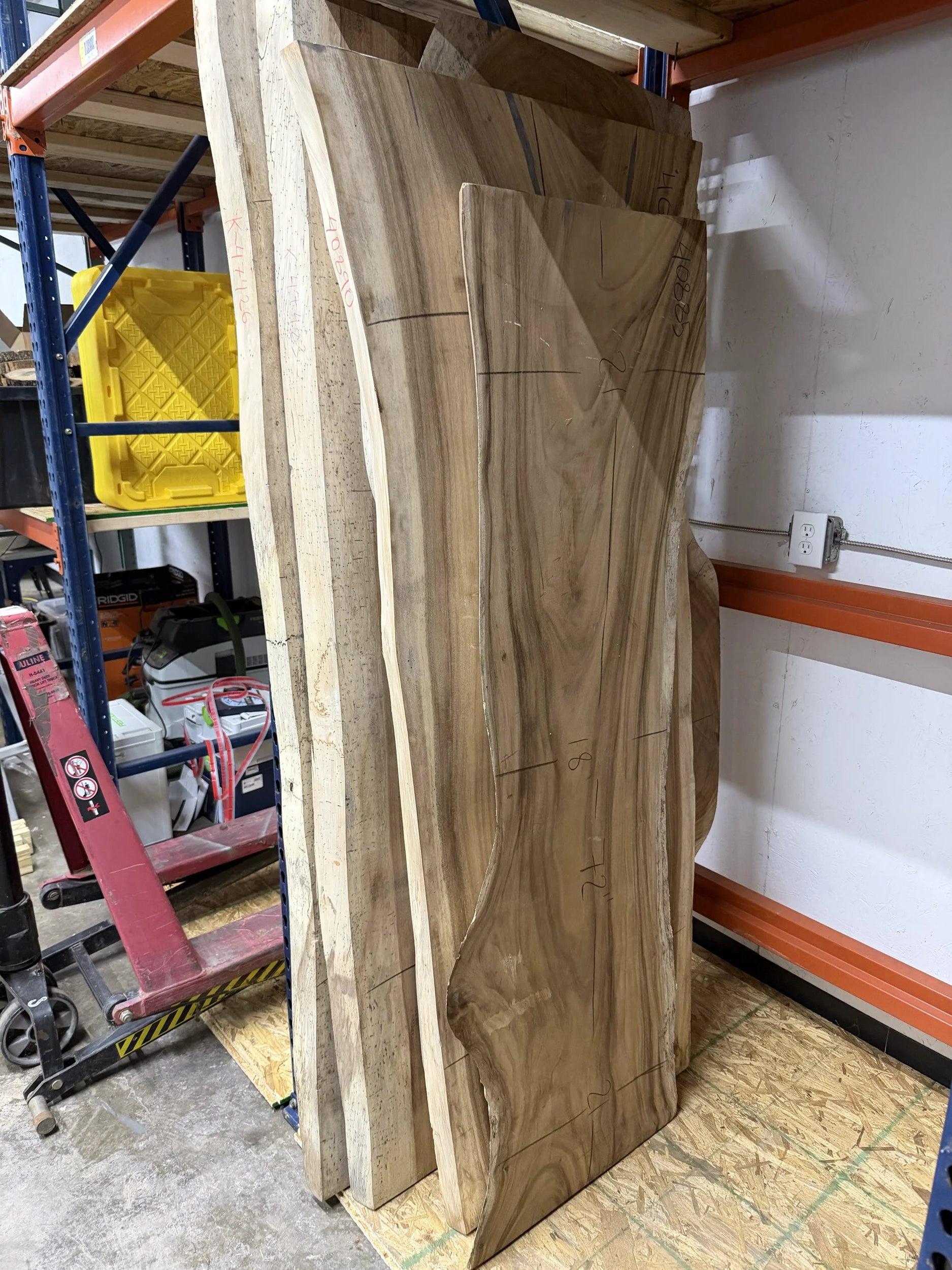 stack of wooden table slabs standing upright