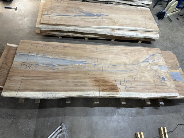 Wooden live edge slab 140x54x2 on a concrete floor with visible markings.