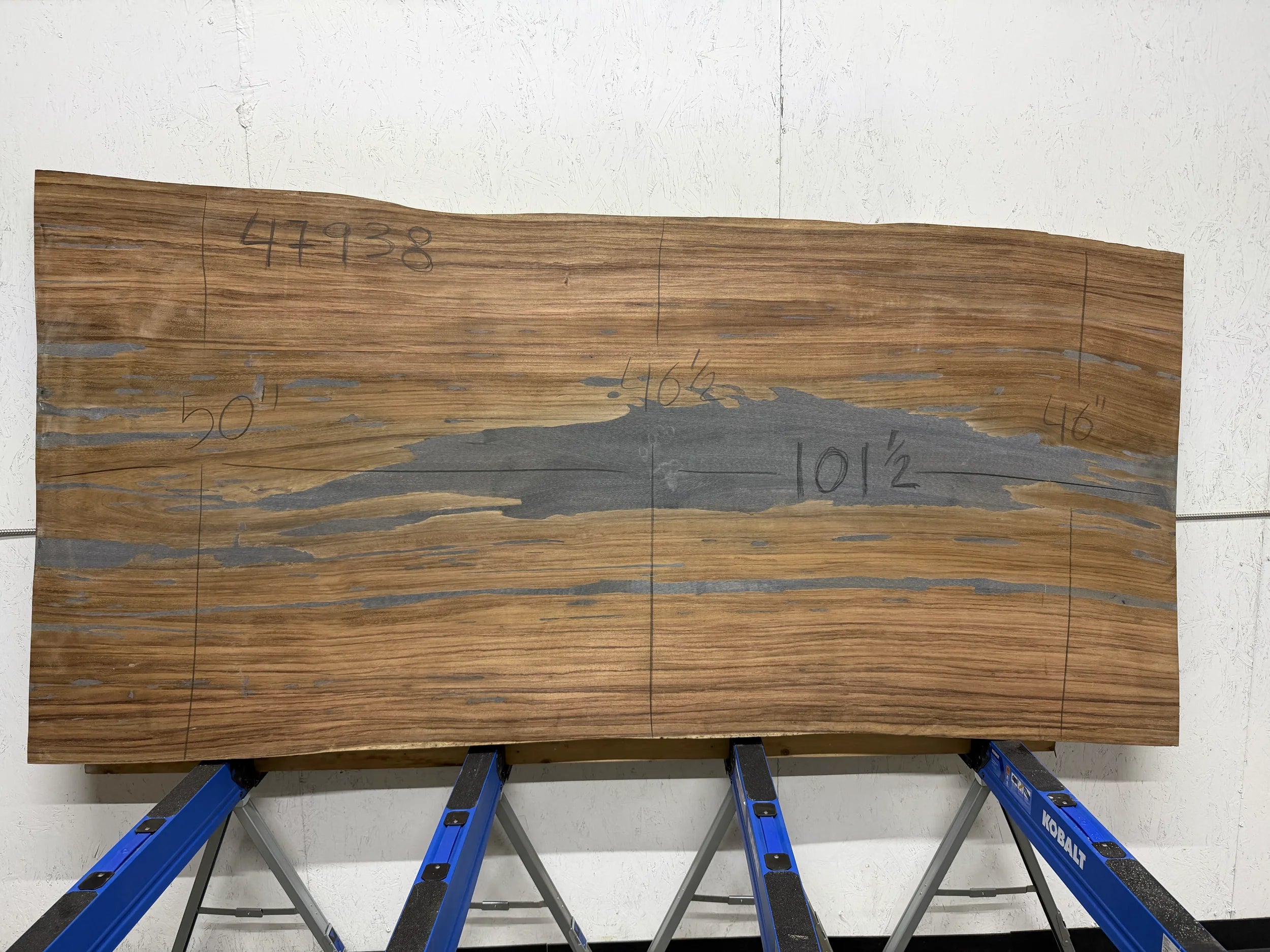 Parota live edge wood slab, 101.5x50 inches, large dining or conference table top on concrete floor.