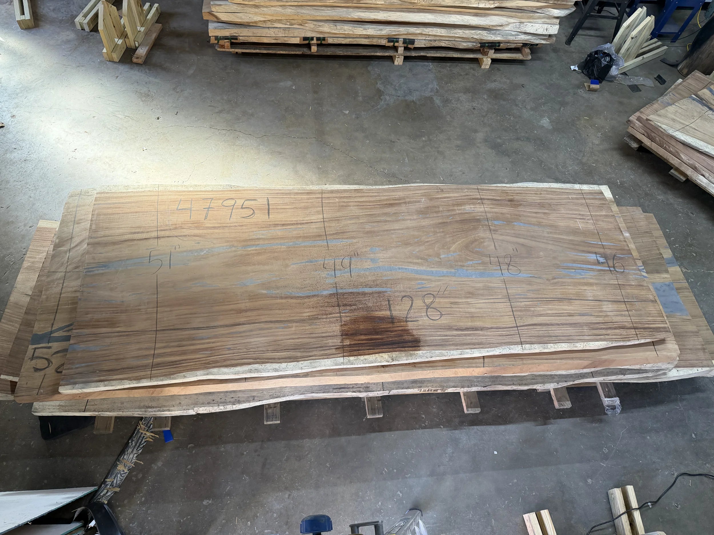 Parota live edge wood slab, 129x51x2 inches, large dining or conference table top on concrete floor.