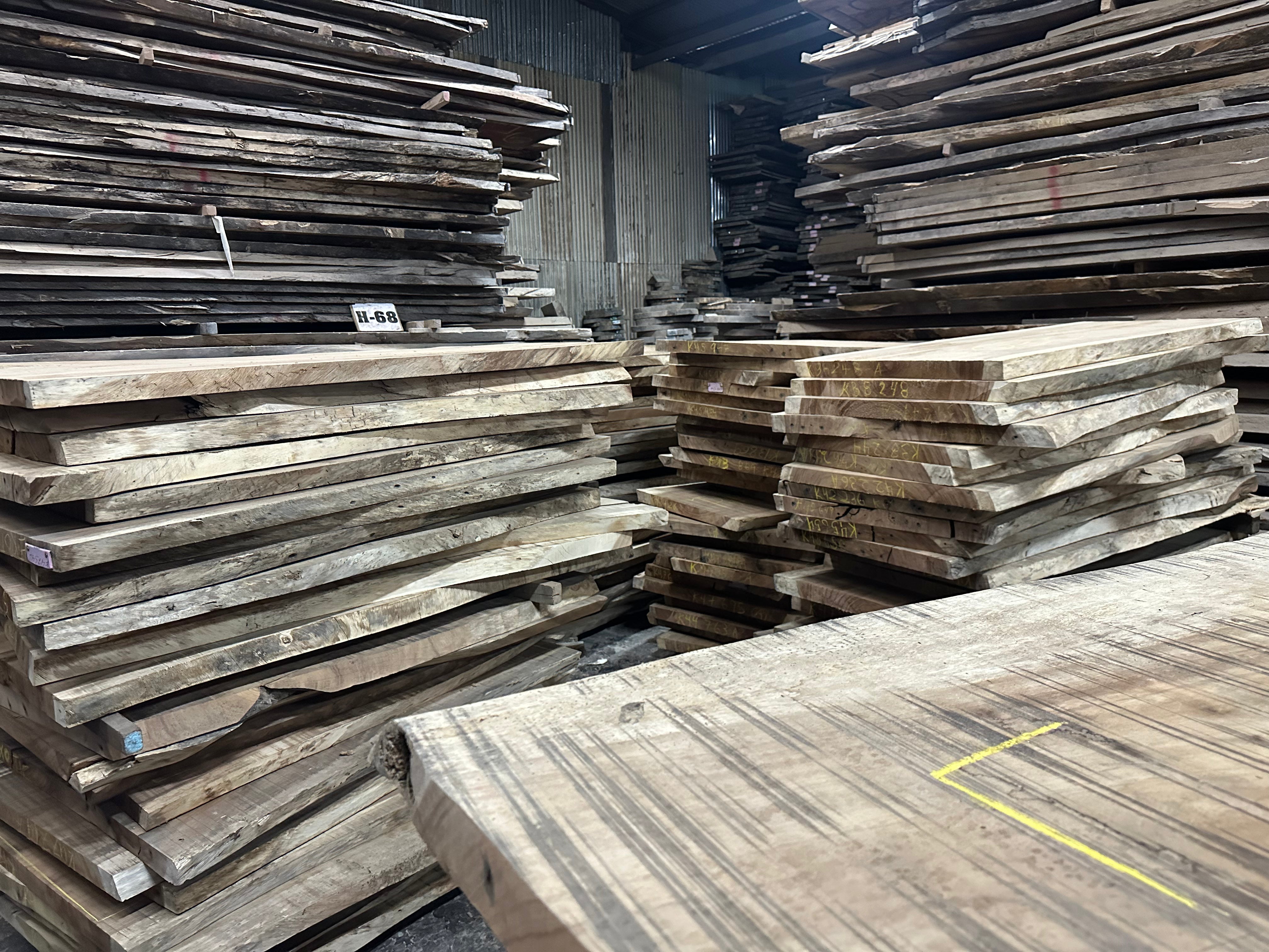 Stacks of wooden planks in a warehouse setting